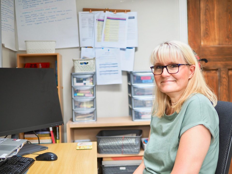 Petra sitting at her desk